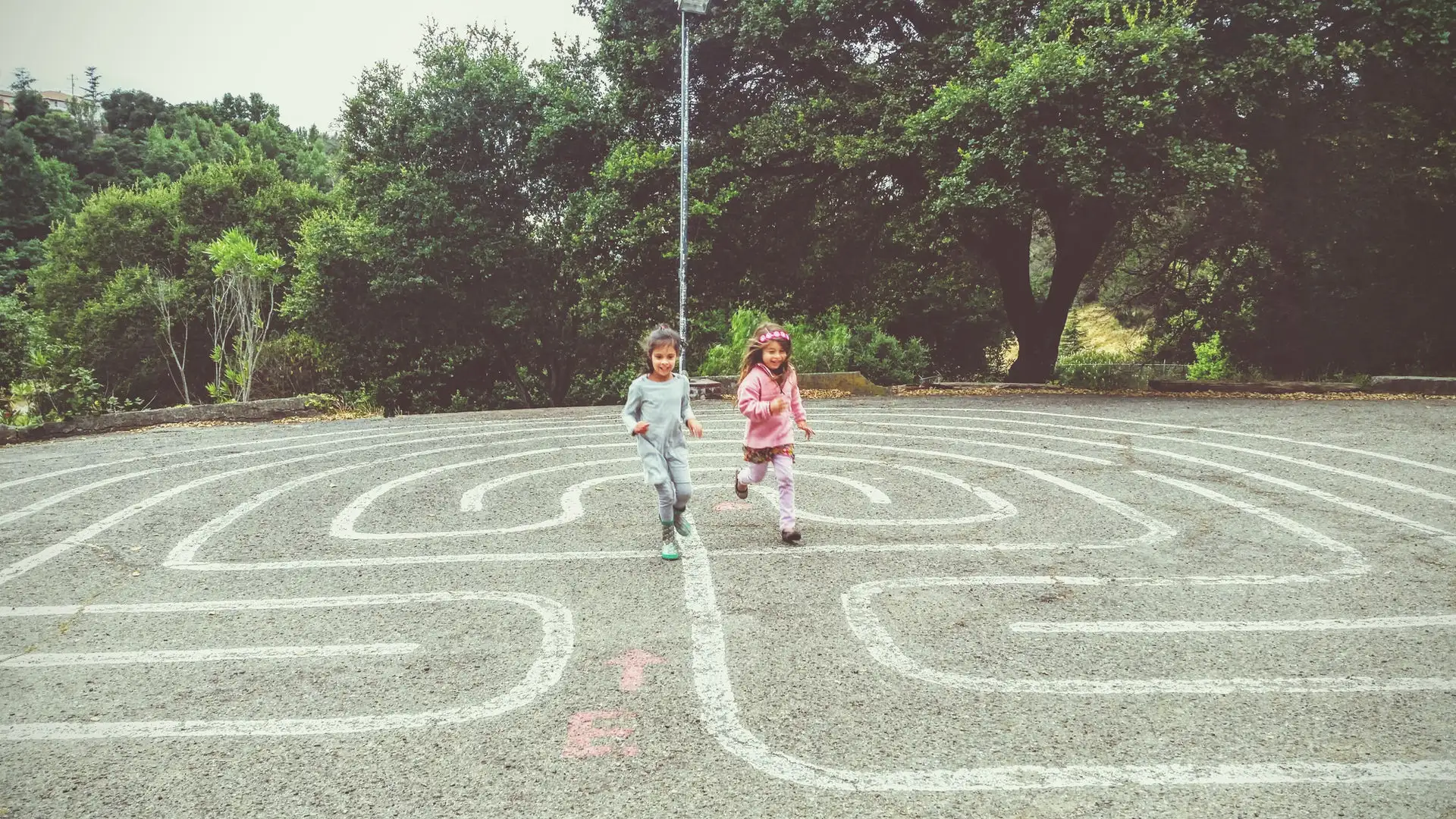 Pear Tree students running on the outdoor labyrinth