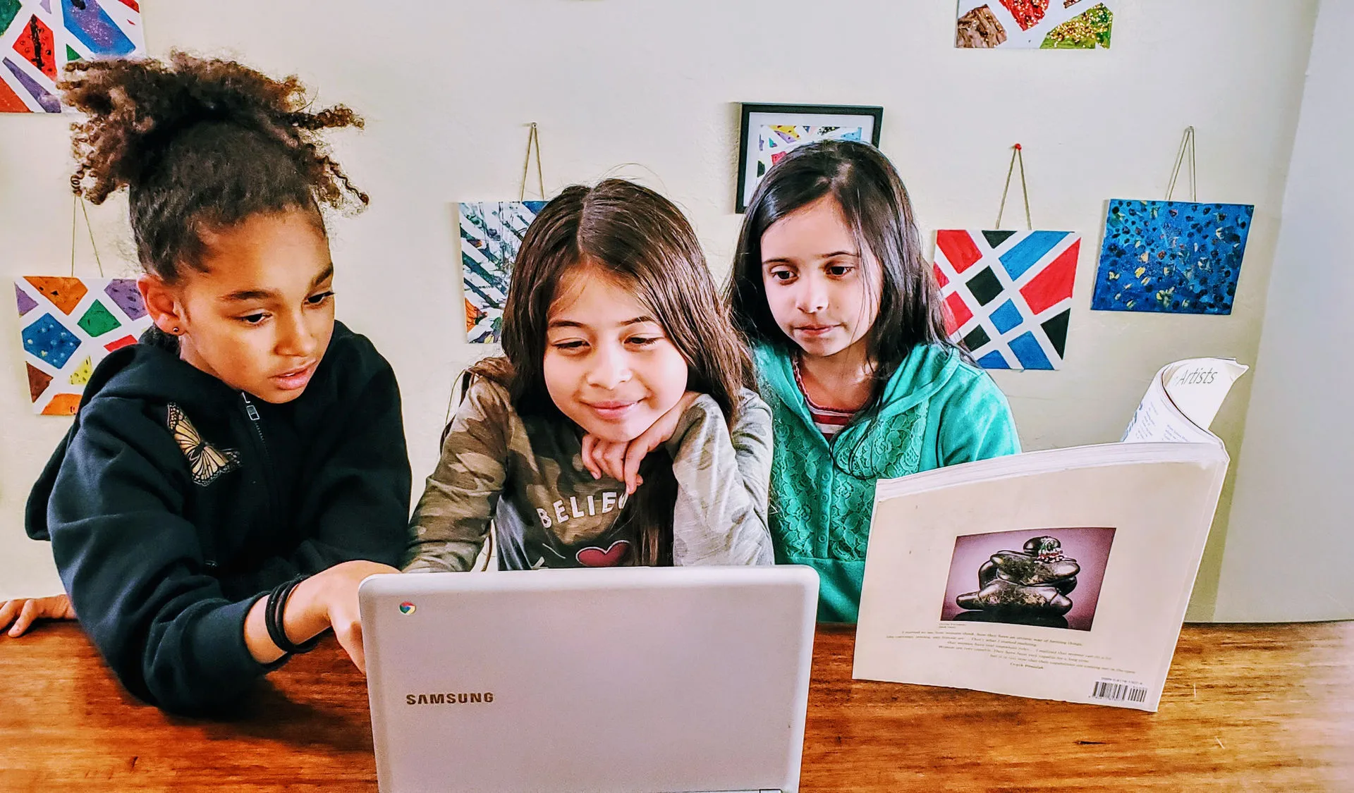 Students collaborating at laptop