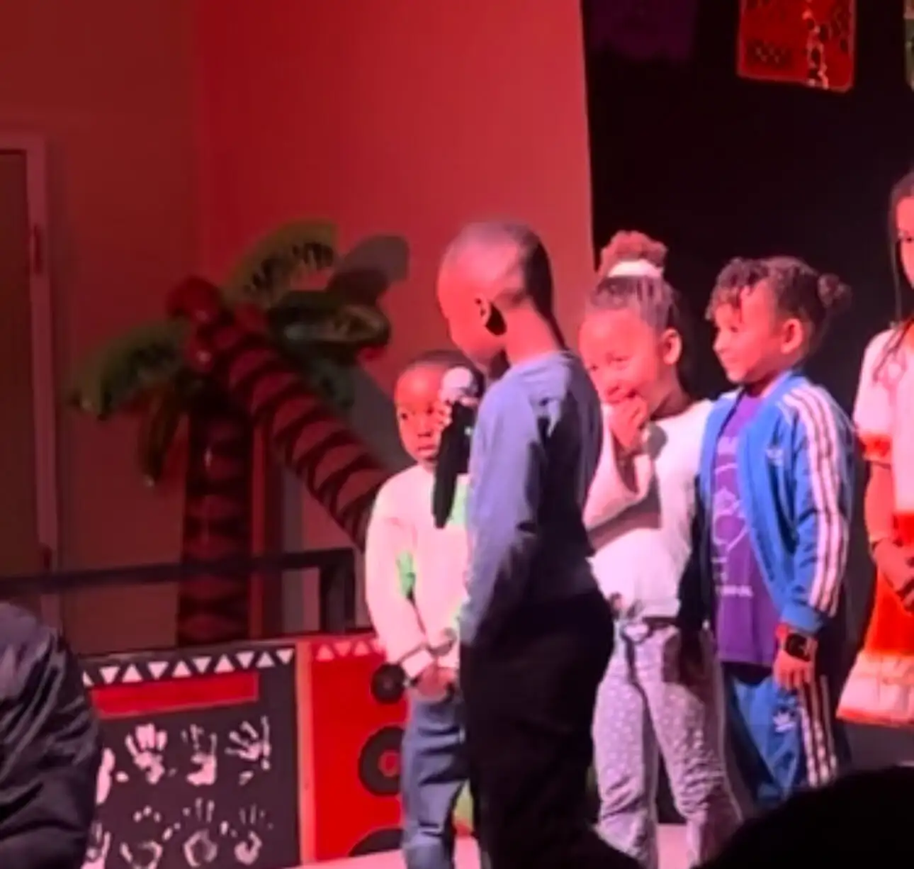 Students performing under papel picado at a school showcase