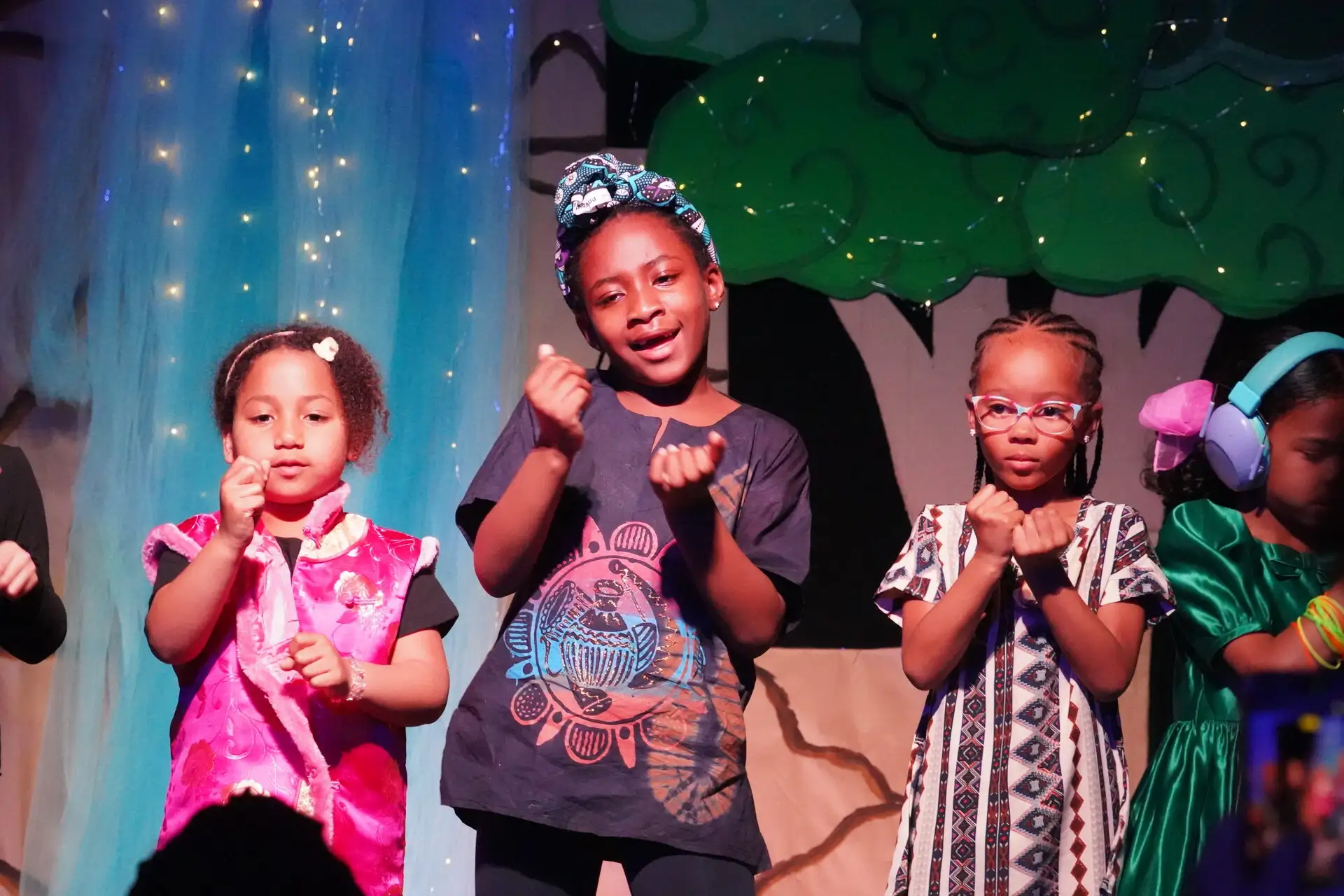Pear Tree students singing on stage at a school performance